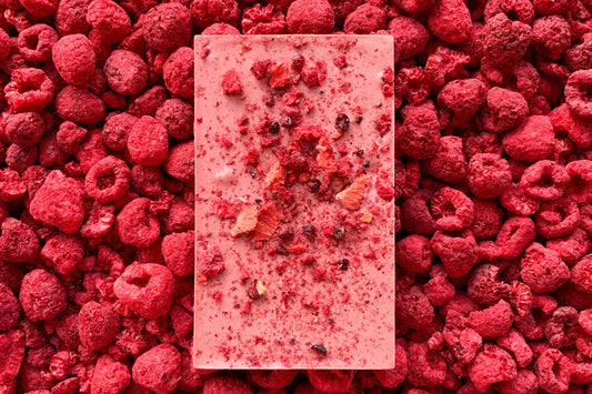 A ruby chocolate bar, handmade by Alicja Confections, covered with freeze dried berries